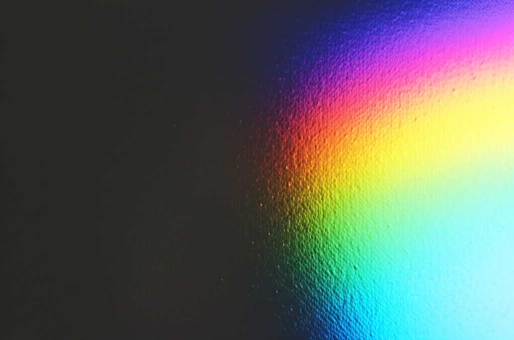 Alt: Abstract streaks of vibrant color appearing to float on a glossy metal surface, hinting at depth and texture.