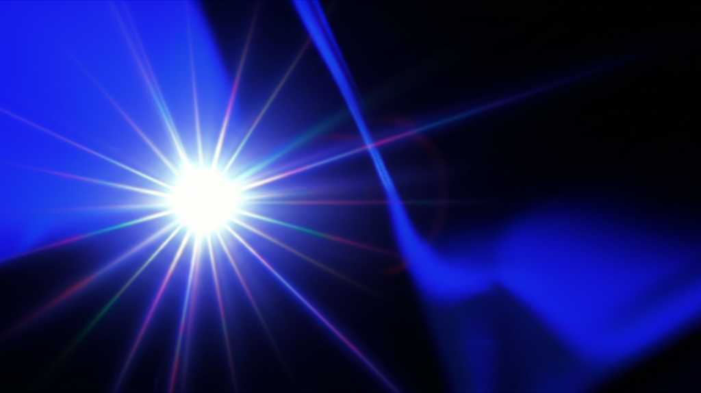 A conceptual image showing light reflecting off a section of a glossy metal print. The image is an extreme close-up, showing a flawless, high-gloss surface that mirrors a soft-focused light source, demonstrating its reflective, acrylic-like quality. The colors beneath the gloss are exceptionally rich and deep.