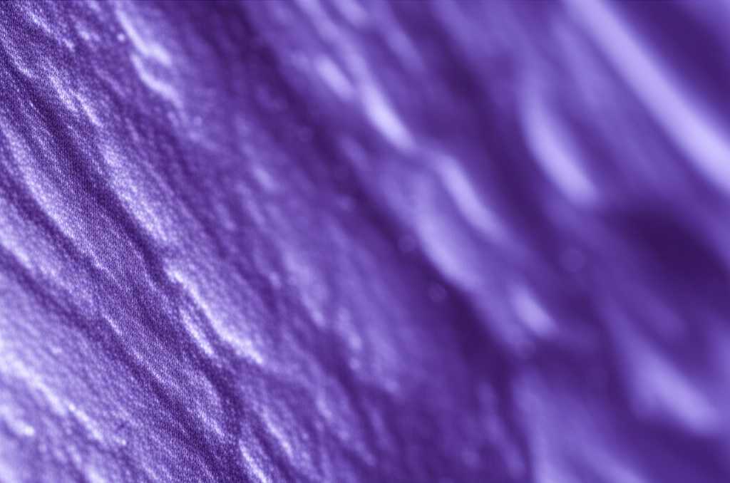 A close-up conceptual image showing light refracting across the textured, glossy surface of a piece of metal art. The focus is on the interplay of light, color, and dimension.
