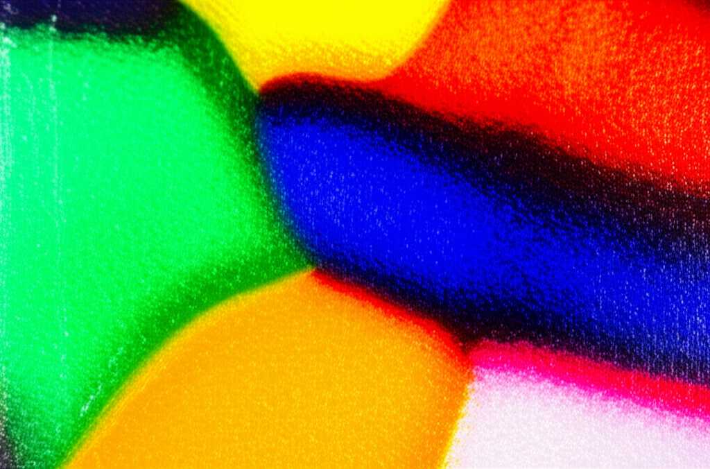 Close-up conceptual image of vibrant Impressionist colors on a glossy, subtly textured metal surface