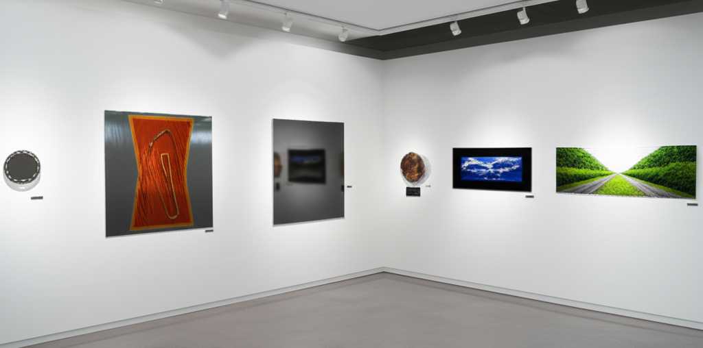 An art gallery-like minimalist setting with diverse styles of generic metal art elegantly displayed.