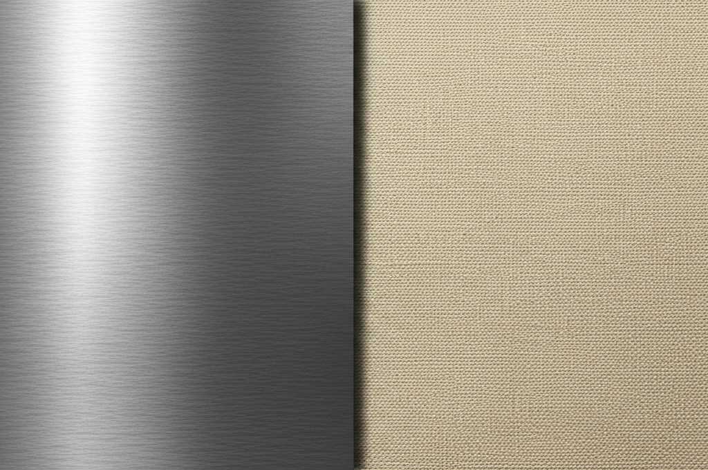 A striking, abstract, colorful artwork subtly suggesting a comparison between a textured metal surface and a traditional canvas weave, with dramatic lighting.