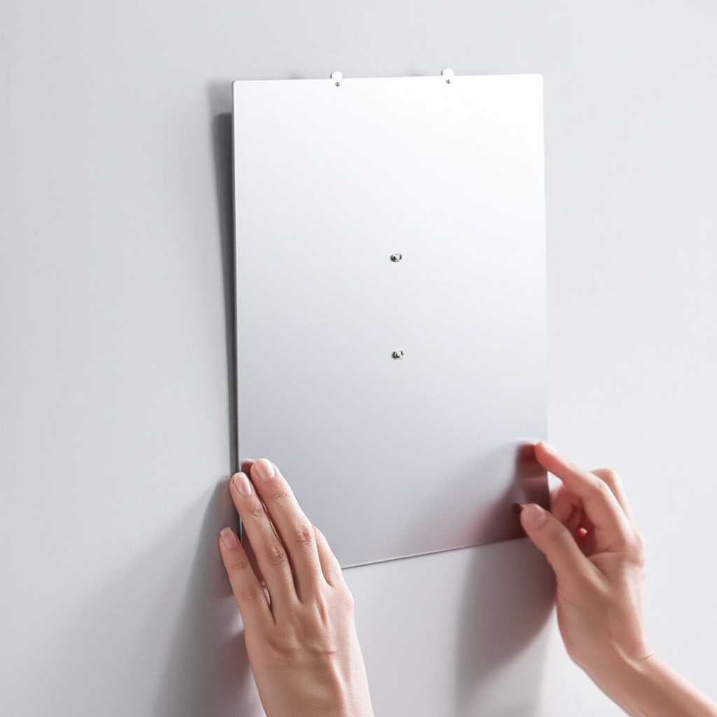 Conceptual image of hands easily placing a generic metal art panel onto a wall using a discreet, modern mounting system (e.g., magnetic dots or a French cleat idea, not overly specific).