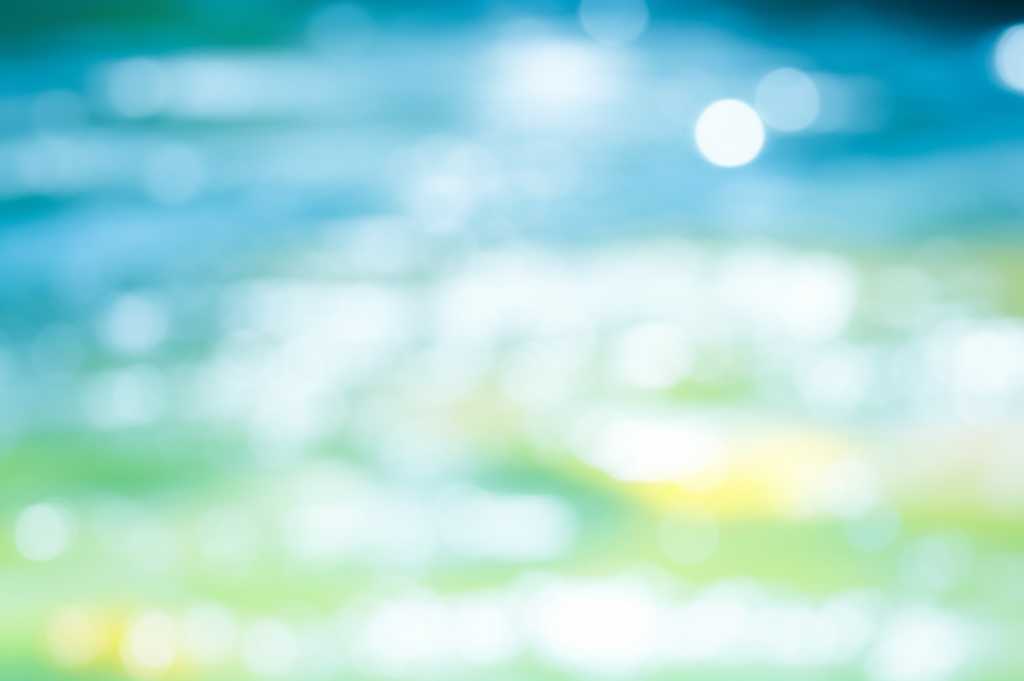 Abstract, dreamlike waterscape evoking Impressionist light and color with dappled sunlight on water, soft focus, and blended hues.