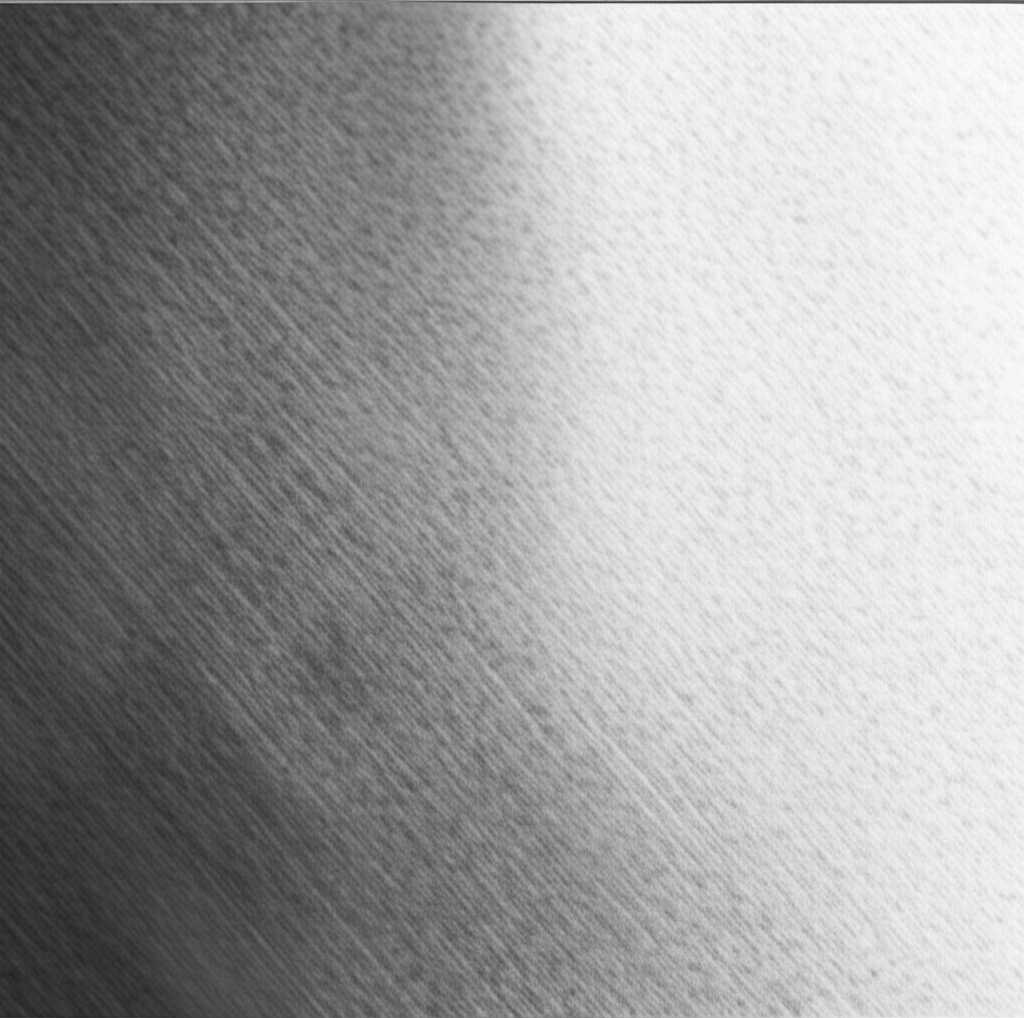 Close-up showing light on a textured metal surface