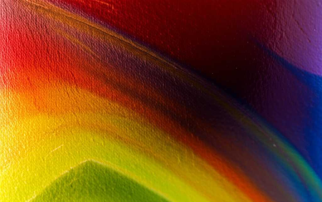 Close-up detail of an intensely colorful abstract artwork printed on metal, showing incredible color saturation and depth.