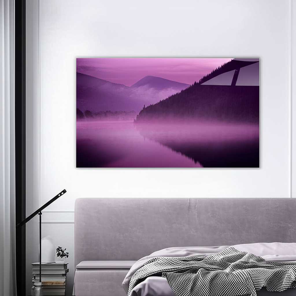 A serene horizontal metal print of a misty mountain range hanging above the headboard of a neatly made bed.