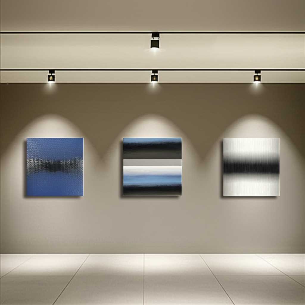 A well-decorated contemporary hallway featuring a series of three medium-sized metal prints with different but complementary abstract designs, illuminated by subtle track lighting.