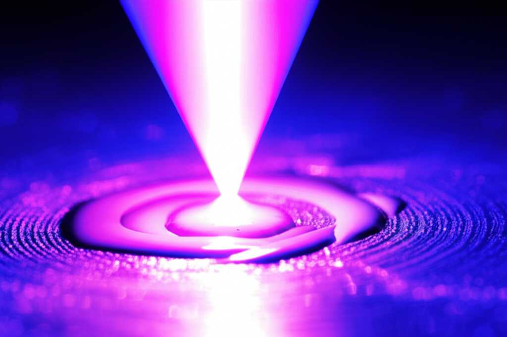 Close-up conceptual image showing UV light curing ink on a metal surface, highlighting texture and gloss