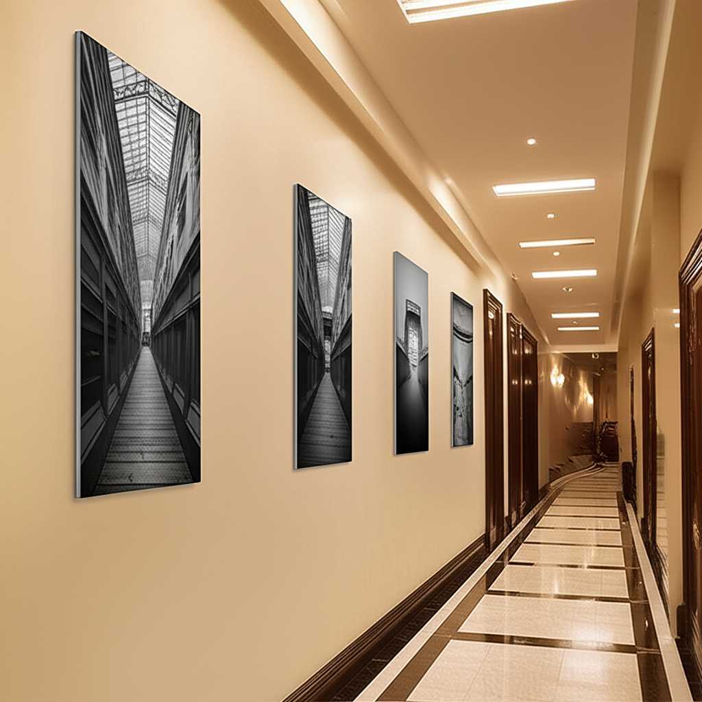 A panoramic shot of a beautifully lit hallway featuring a series of vertically aligned, sleek metal photo prints, creating a sophisticated gallery effect