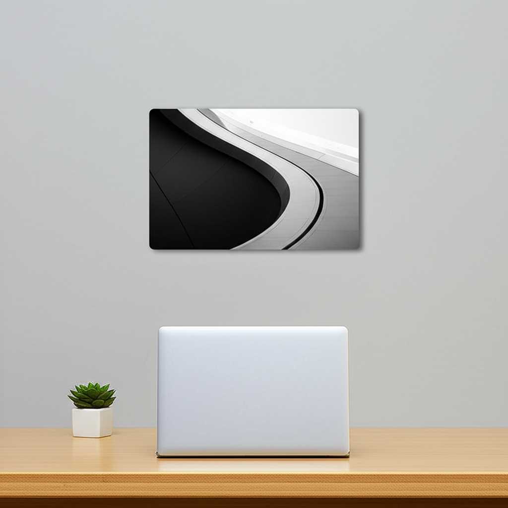 An impeccably organized and stylish home office. A single, medium-sized metal print with a minimalist architectural design hangs on the wall above a clean, wooden desk. The space is bright and free of clutter, conveying a sense of focus and productivity.