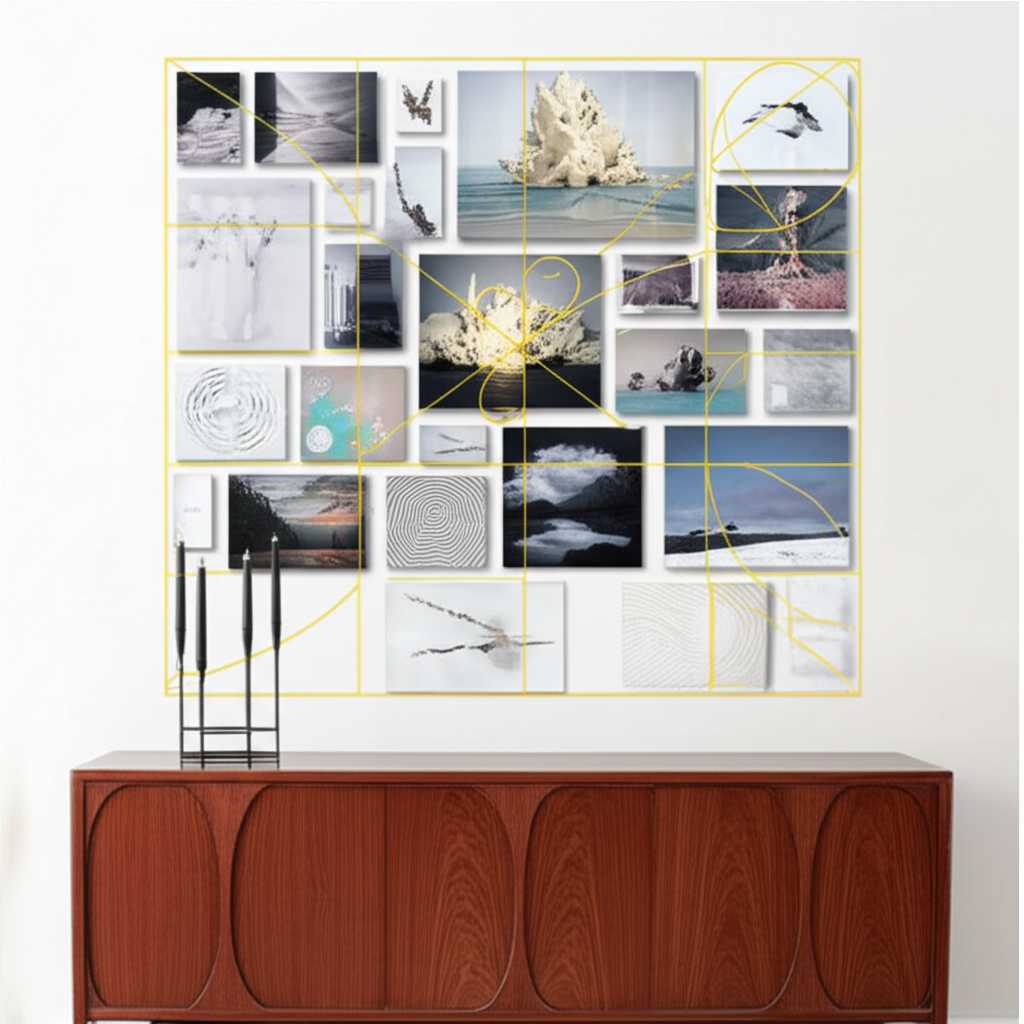A stylish gallery wall arranged above a credenza. The pieces are arranged within a faint, glowing outline of a Golden Rectangle, with the largest piece positioned at a key intersection point of the grid.