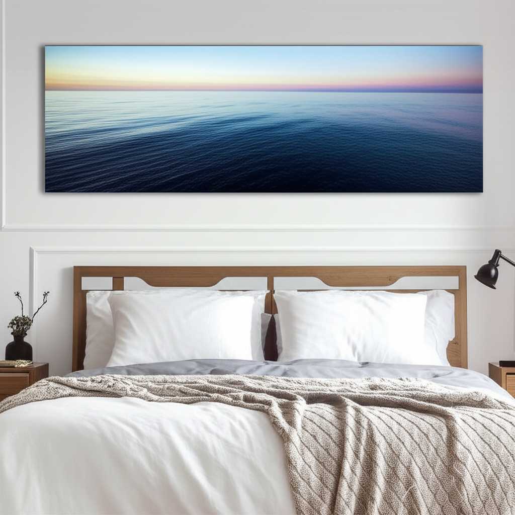 A serene bedroom with a large metal print of a tranquil ocean scene above the bed, its glossy surface reflecting the soft morning light.