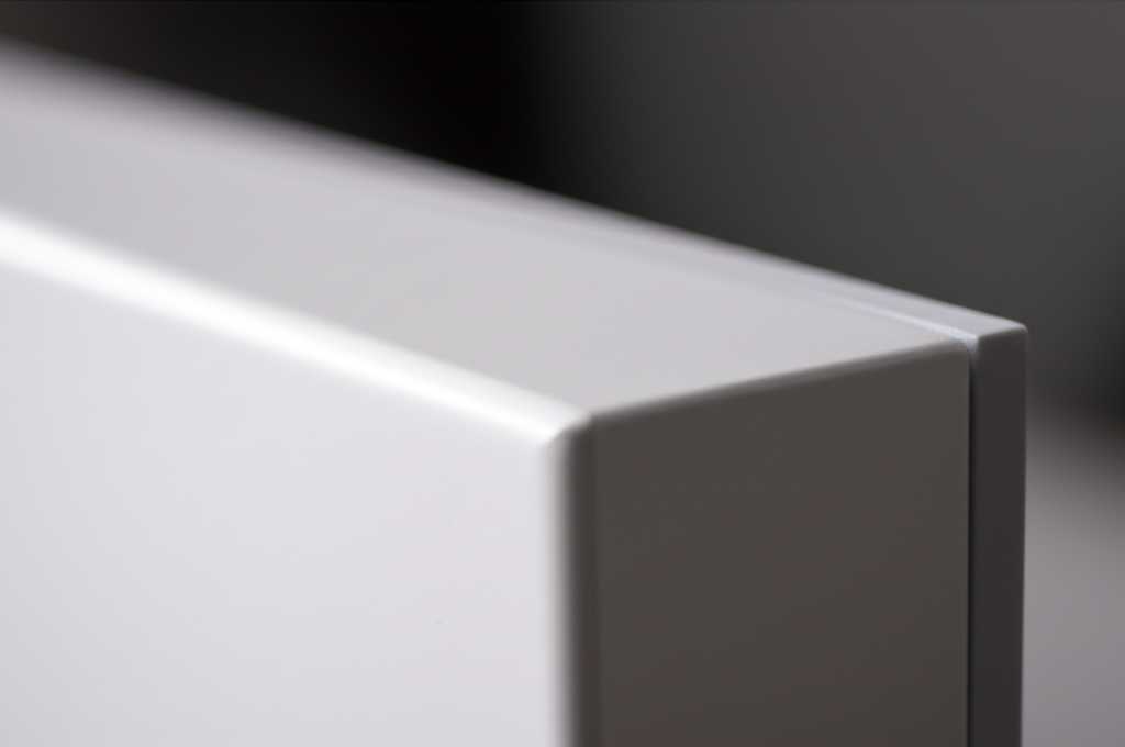 Artistic close-up on the edge and corner of a generic, thick (e.g., 3mm) metal print, highlighting its substantial build quality and sleek finish, with a softly blurred background.